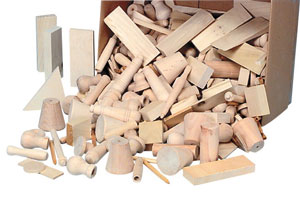 Box of unpainted wooden components. Wooden crafting shapes