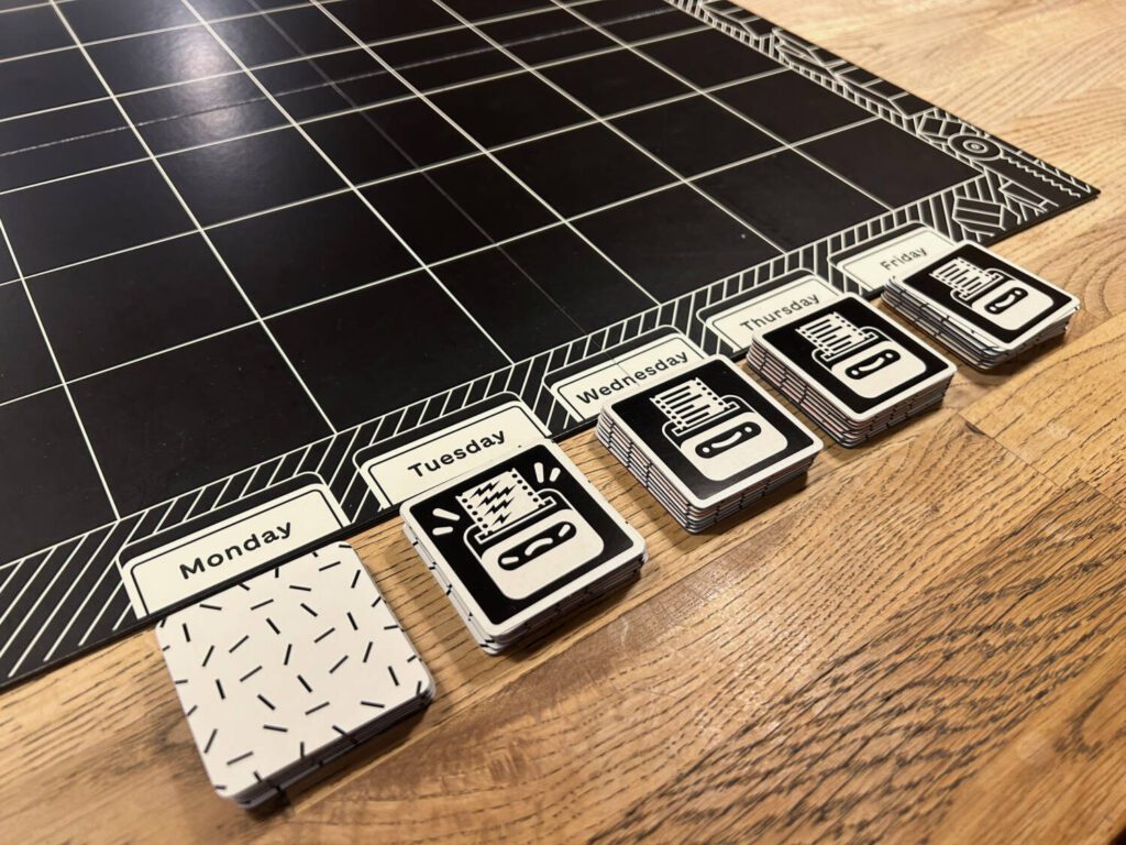 Five stacks of seven tiles with white backs. Four of the stacks have a challenge card on top…</p>
<p>The post <a href=