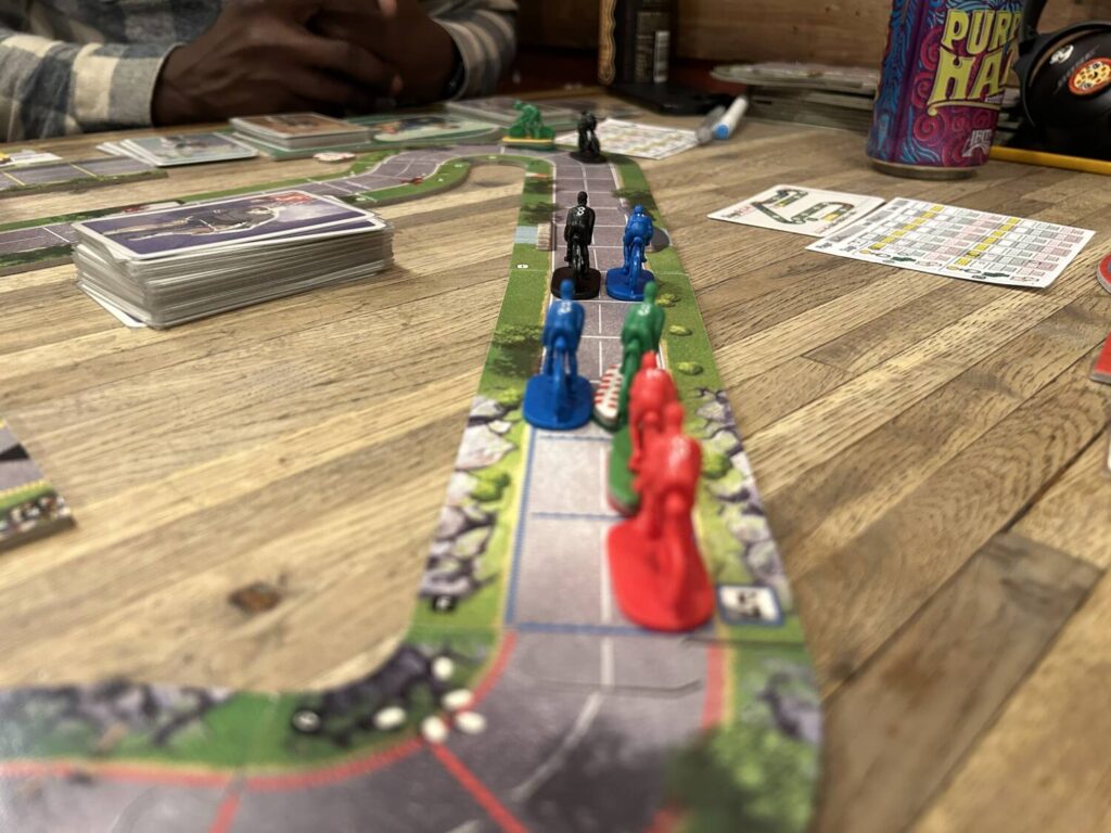 Cyclists all in a row on a straightaway.