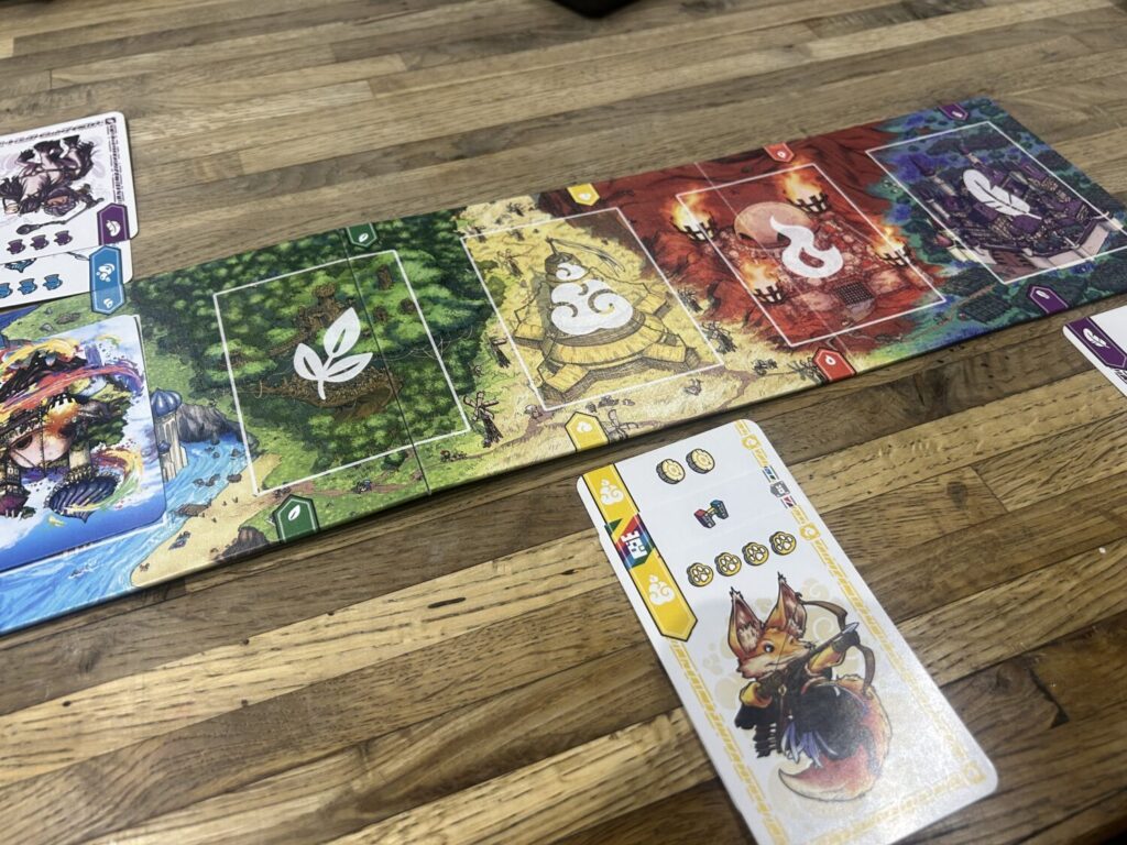 The board, a few turns into a game. Four cards sit to the south of the board, three sit above it.