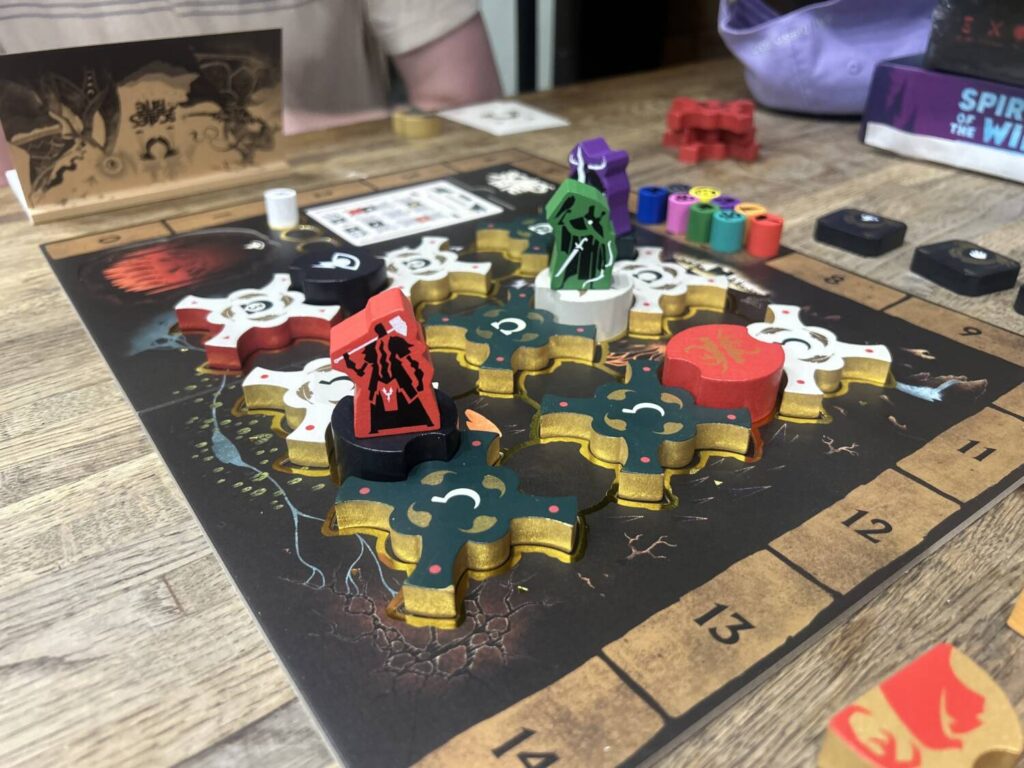 A baroque game board on a wooden table. A lengthy description of the board follows in the text of the review.